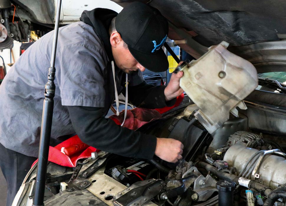 A Horsman technician carefully working on a customer's engine